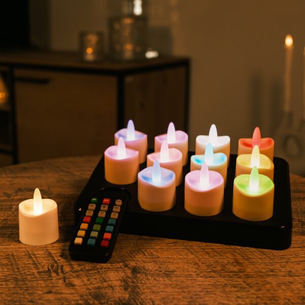 Een set van 12 RGB LED-Waxine/theelichtjes oplaadbaar waterdicht met afstandsbediening staat binnen op een houten tafel, met één waxinelichtje apart van de groep.